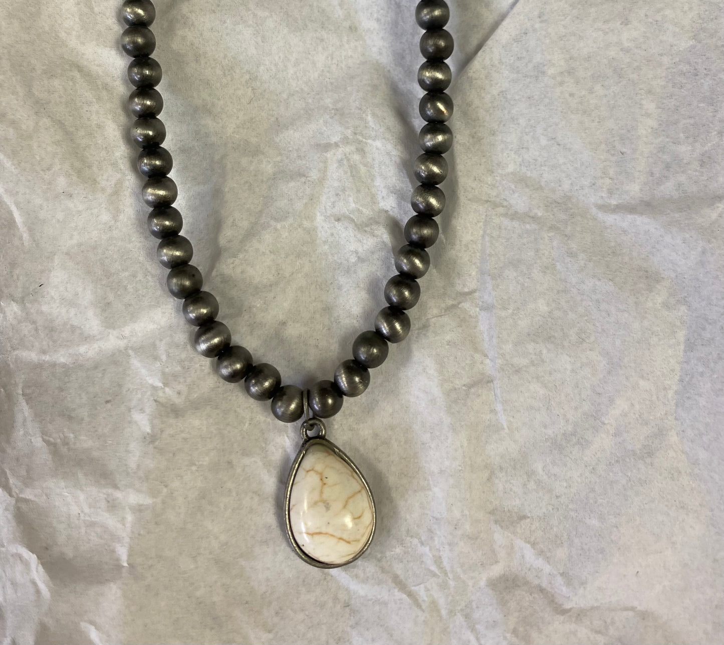 Choker necklace, turquoise and brown stone with concho accent.