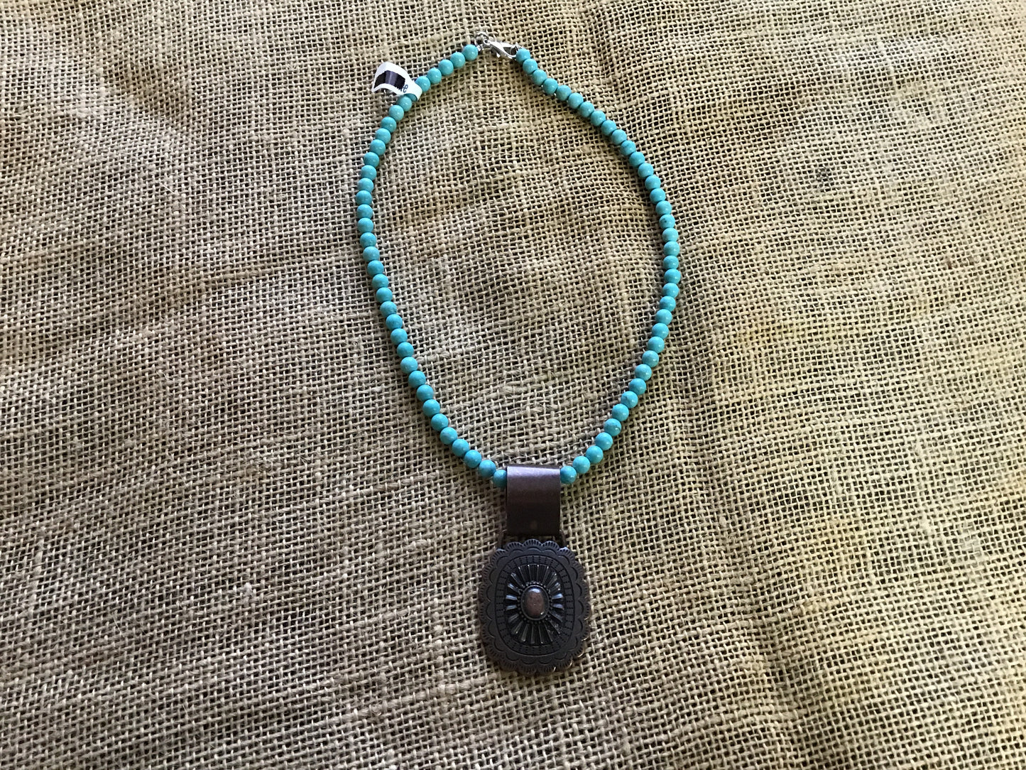 Choker necklace, turquoise and brown stone with concho accent.