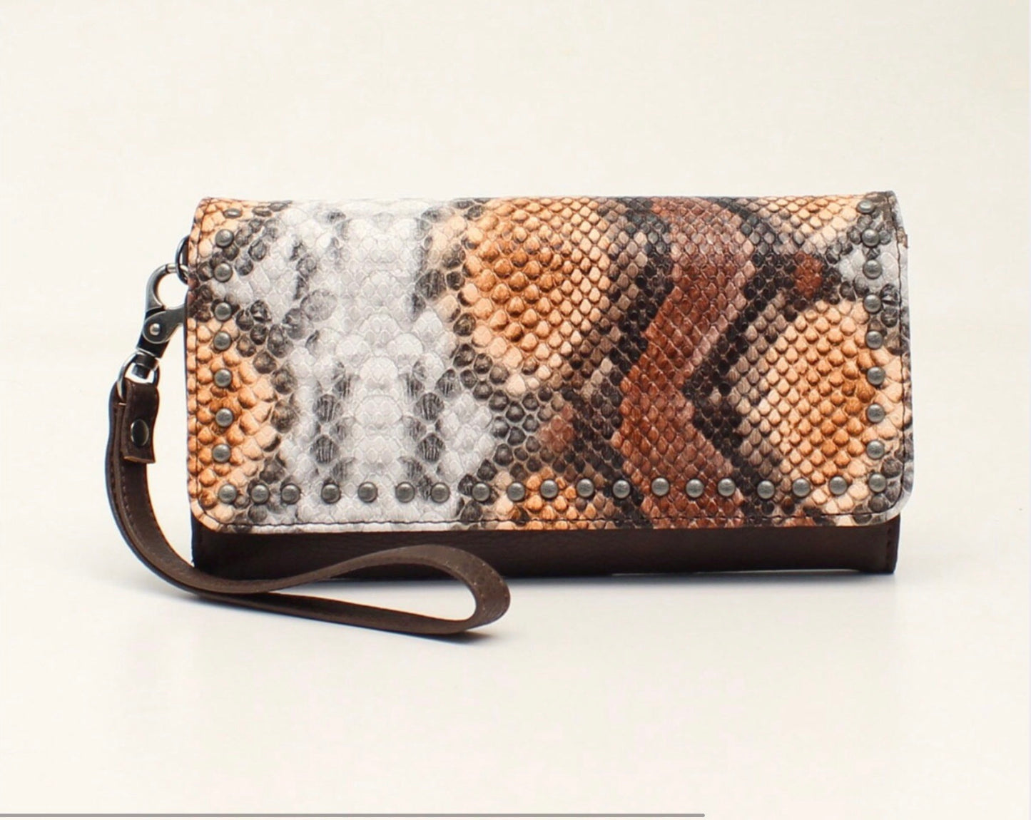 D330000302 Angel Ranch Clutch Wallet Brown Measures: 4 x 1 x 7-1/2 Python Print Antique Nail Heads Magnetic Closure Interior: 2 Pouches with Zippered Center Coin Pouch Multiple Card Slots and ID Slot