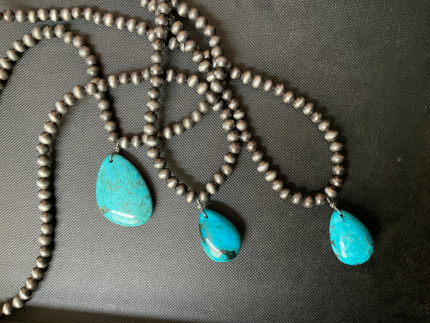 Choker necklace, turquoise and brown stone with concho accent.