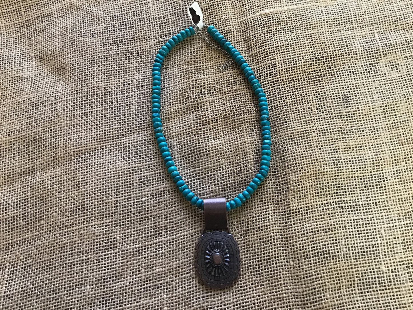 Choker necklace, turquoise and brown stone with concho accent.