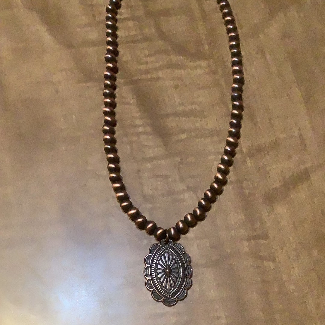 Choker necklace, turquoise and brown stone with concho accent.