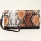 D330000302  Angel Ranch Clutch Wallet Brown Measures: 4 x 1 x 7-1/2 Python Print Antique Nail Heads Magnetic Closure Interior: 2 Pouches with Zippered Center Coin Pouch Multiple Card Slots and ID Slot