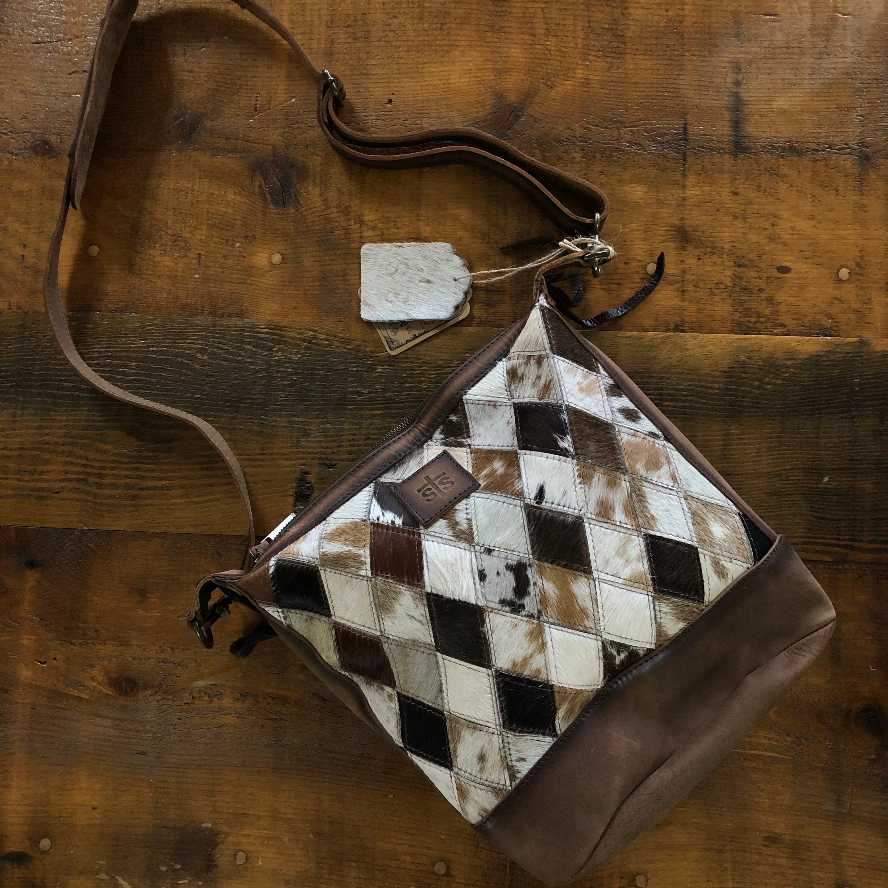 Cowhide and Leather YES PLEASE!! Backpacks are all the rage as your daily  purse/bag right now. Also, more and more moms are carrying backpacks as  diaper bags. Such a versatile piece that